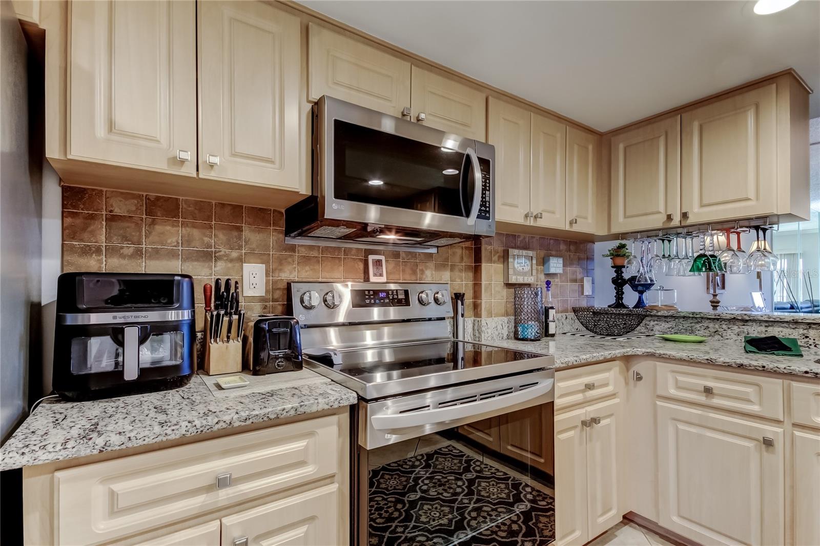 Another view of the kitchen showing the range and microwave.