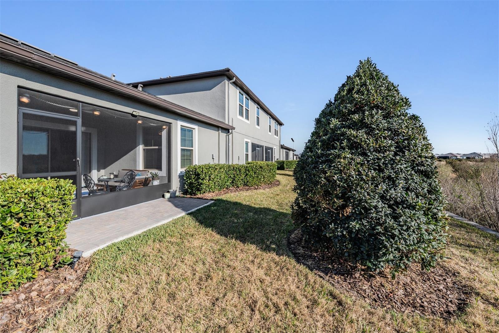 Backyard has open patio to BBQ or sunbathe