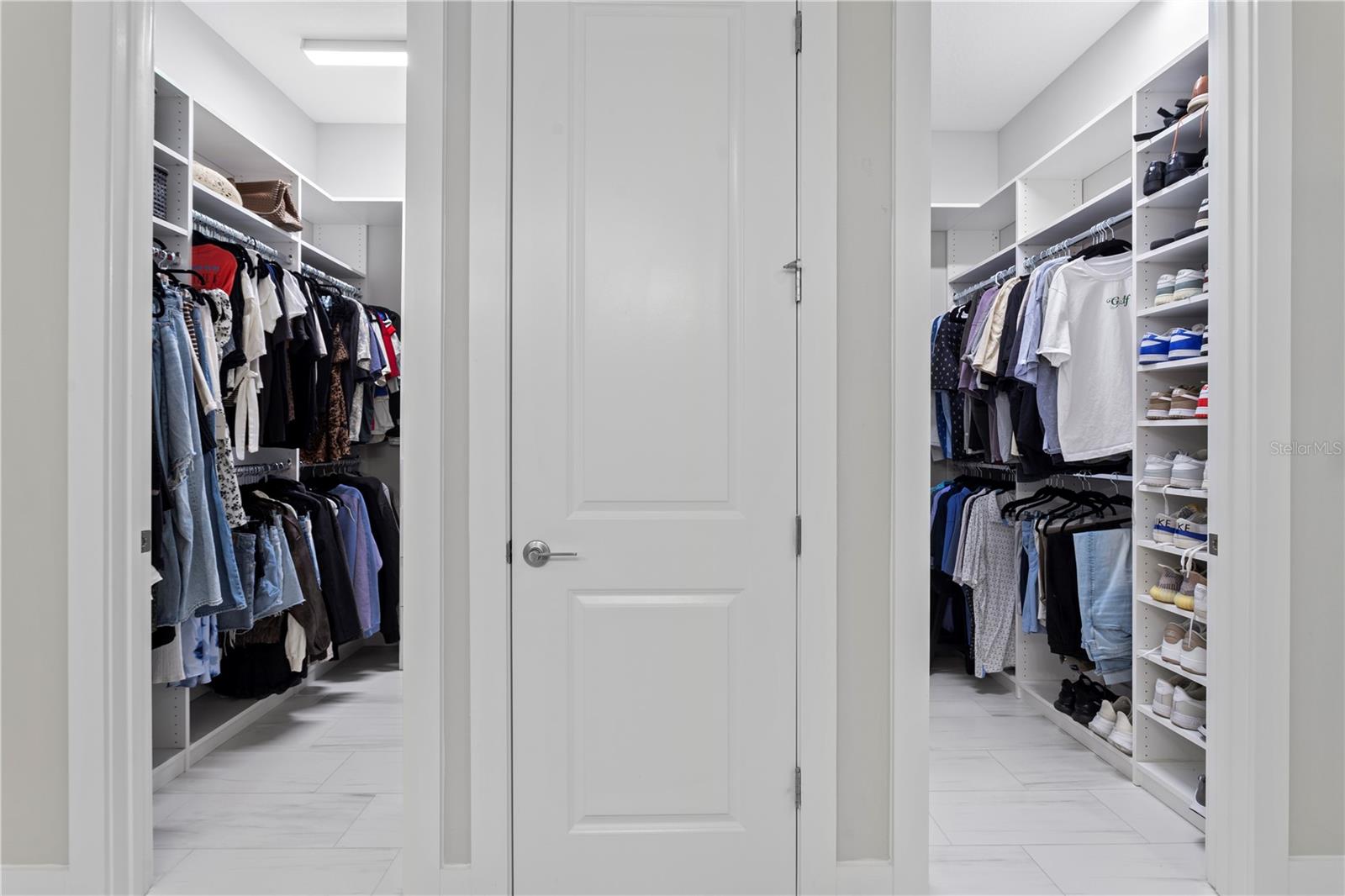 Dual custom walk-in closets for maximum organization.