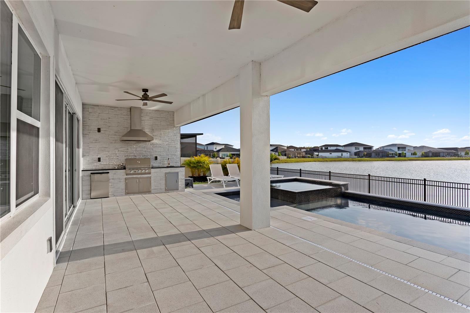 Outdoor living space with motorized patio shades.