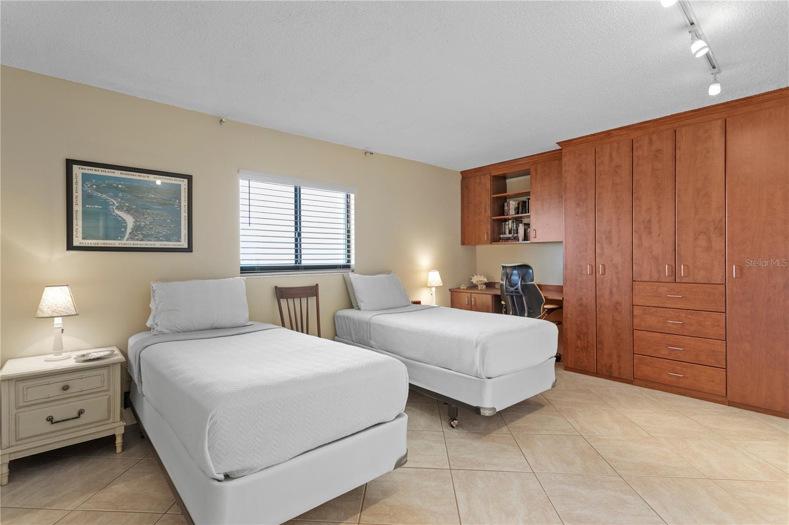 The second bedroom comfortably accommodates bunk beds or two twins and includes smart in-wall storage.