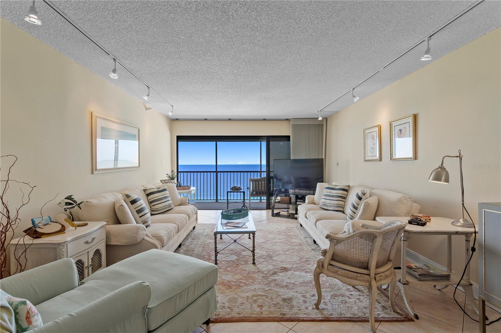 The airy living room is bathed in natural light, creating a warm and welcoming space to relax or entertain.