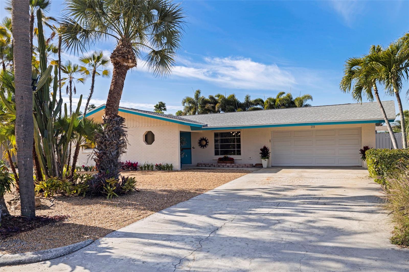 2-car garage with generous parking, new epoxy floor and bonus workshop space.