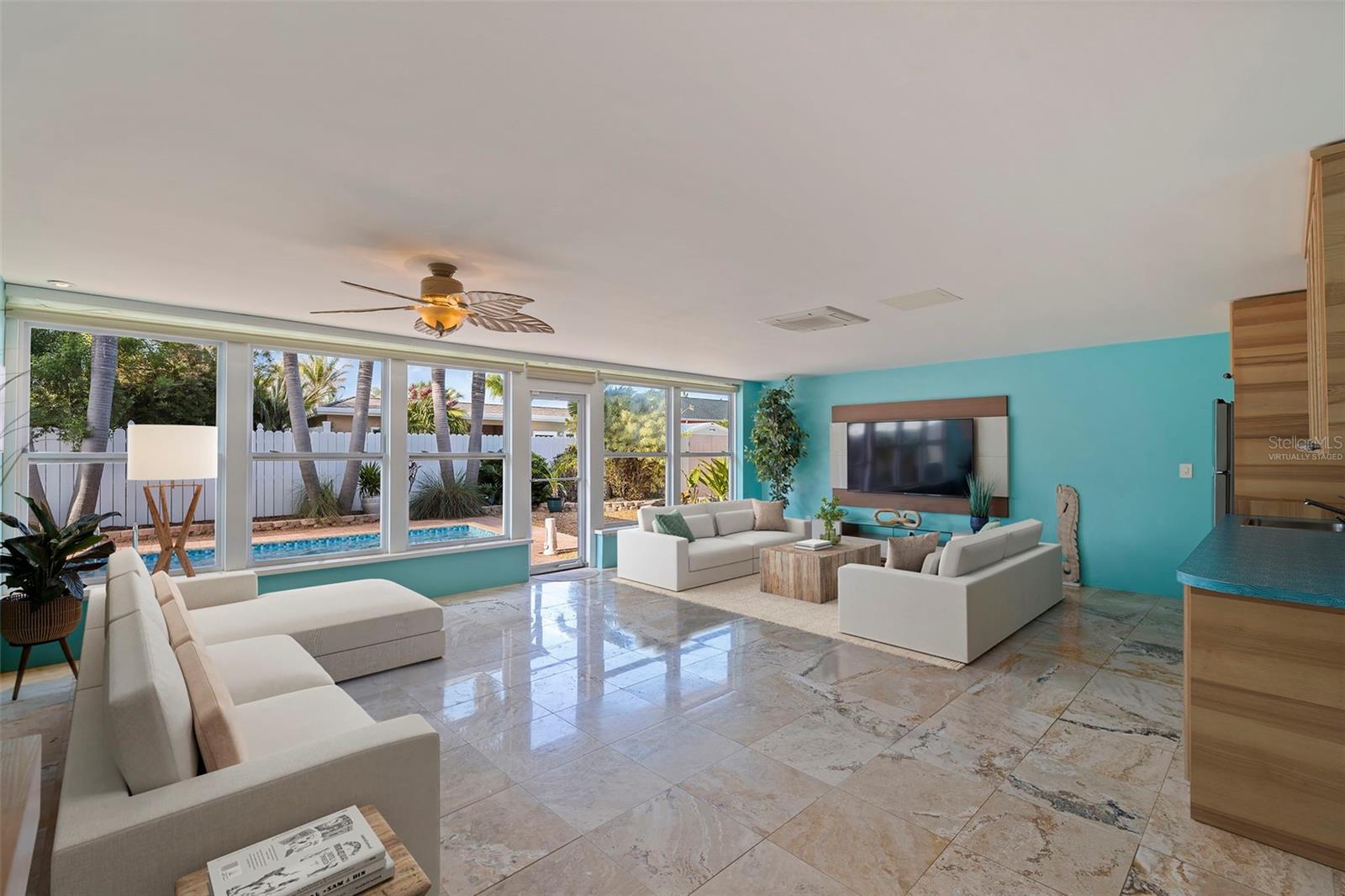 Virtually Staged pool and additional seating space shown in family room.