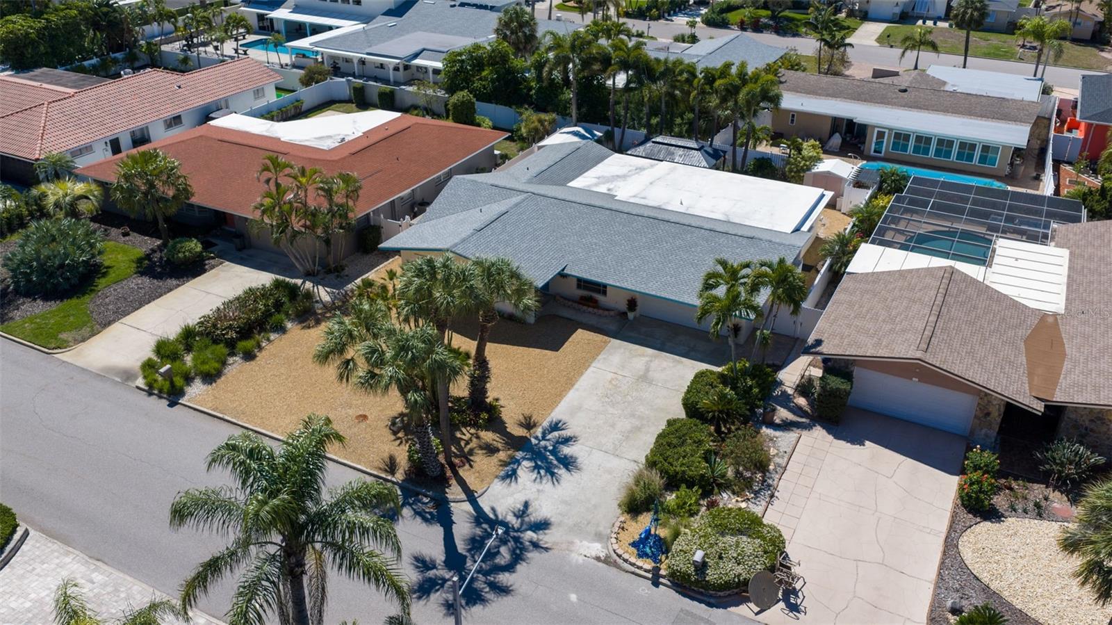 Low-maintenance yard with landscape stone and indigenous tropical plantings.