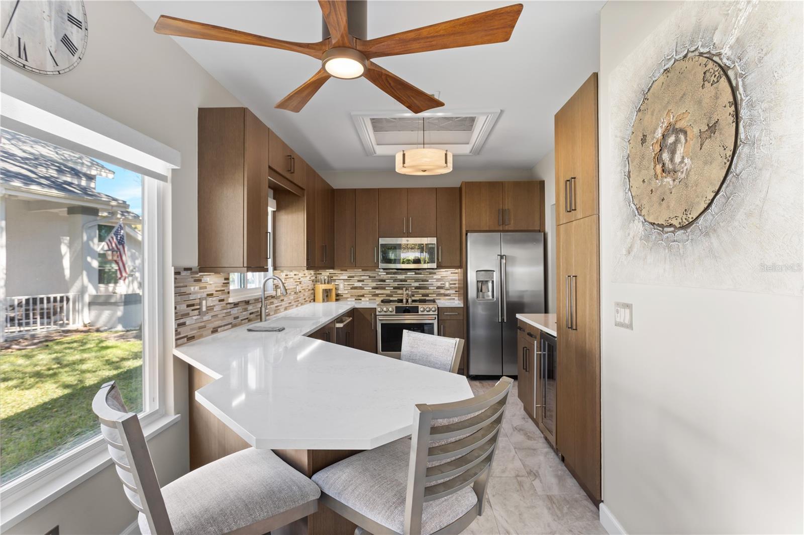 Custom Kitchen with High End Cabinetry, Stainless Steel GE Cafe' Appliances and Quartz Countertops