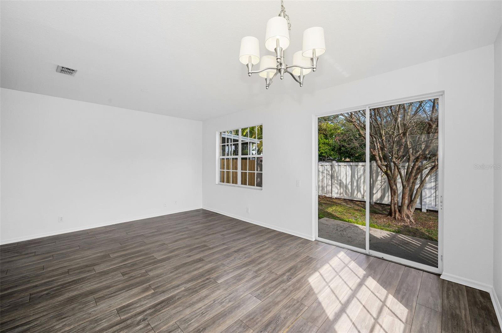 Sliders lead to the back patio and yard.