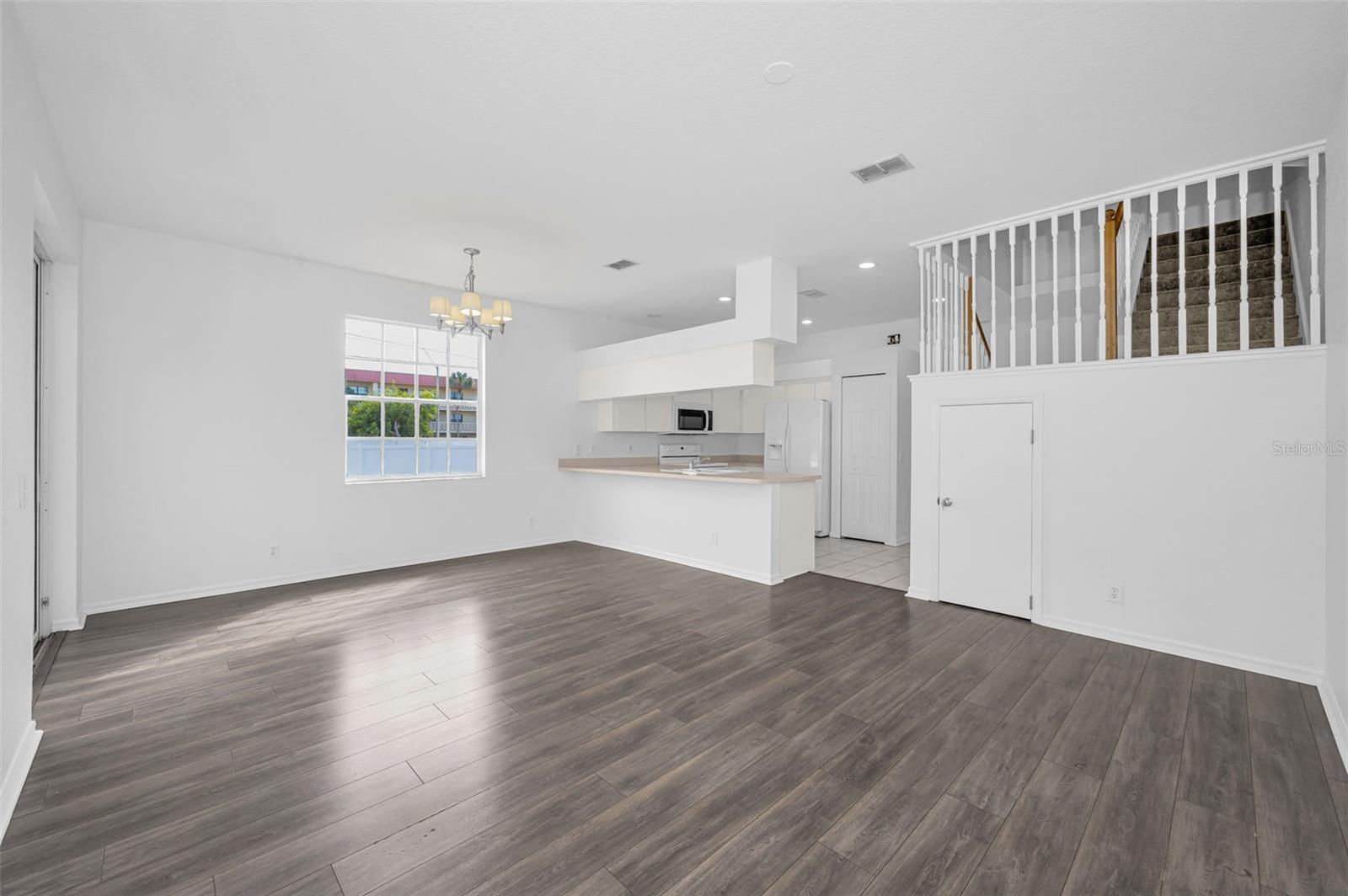 The Kitchen overlooks the Great Room which combines the Living Room and Dining Area.