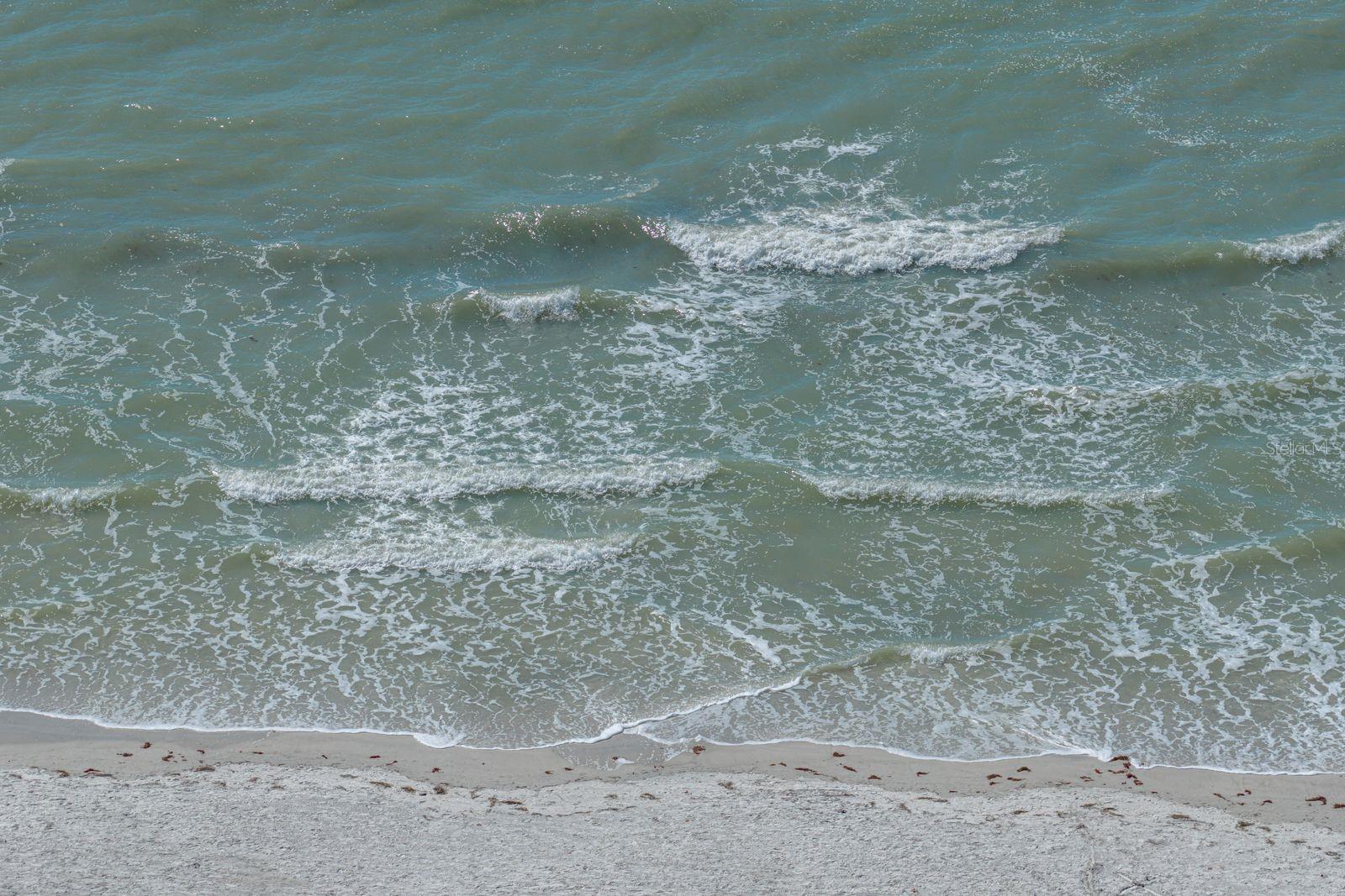 Warm gentle waves are steps from your condo