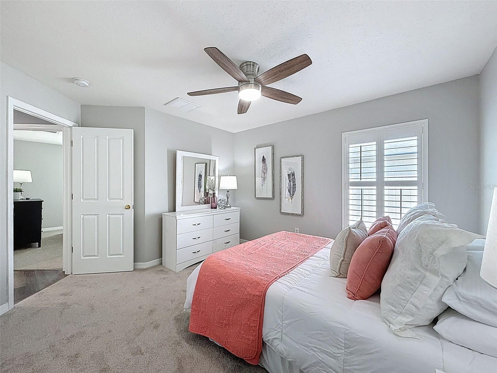 Spacious second bedroom with large closet, new carpet, new fan and plantation shutters.