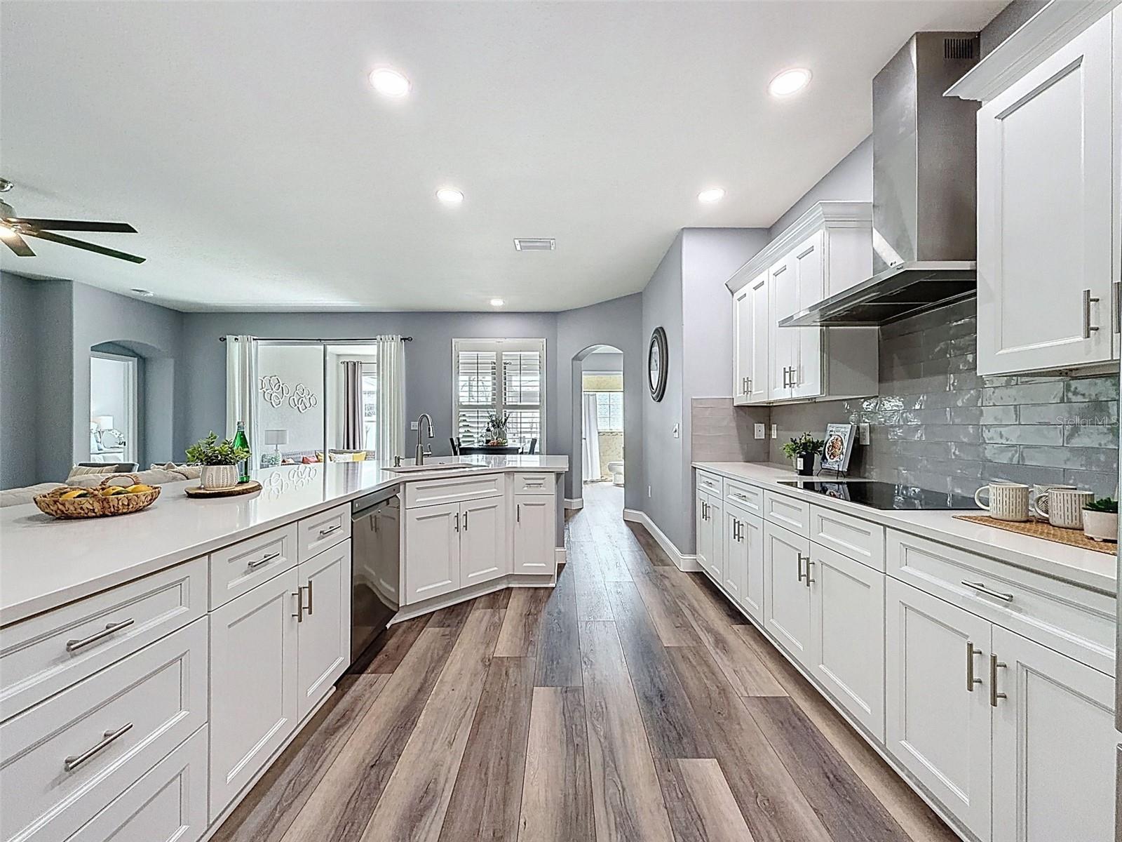 Large solid stone kitchen island offers more storage and plenty of seating.
