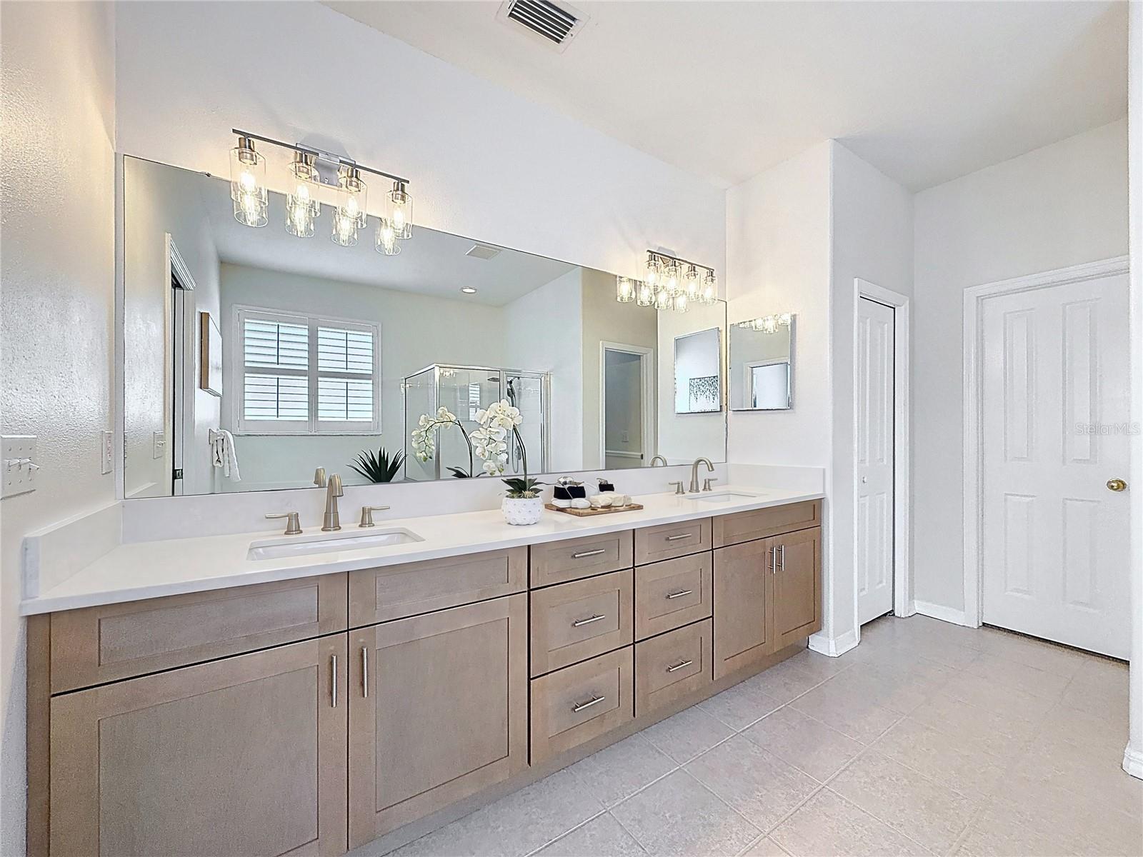Master bath with linen closet on left and entrance to extra-large walk in closet.