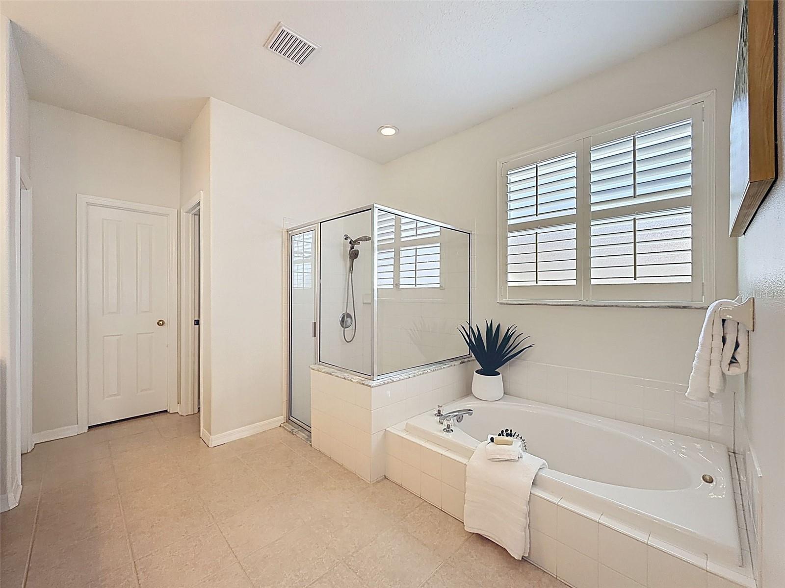 Huge master bathroom offers sunken tub, walk in shower and water closet for privacy.