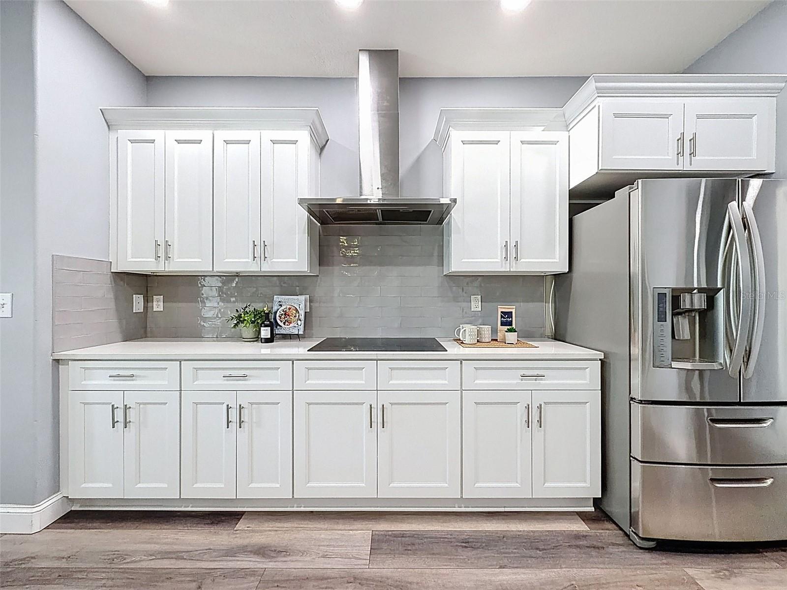 Beautiful cooking space with lots of solid wood cabinets.