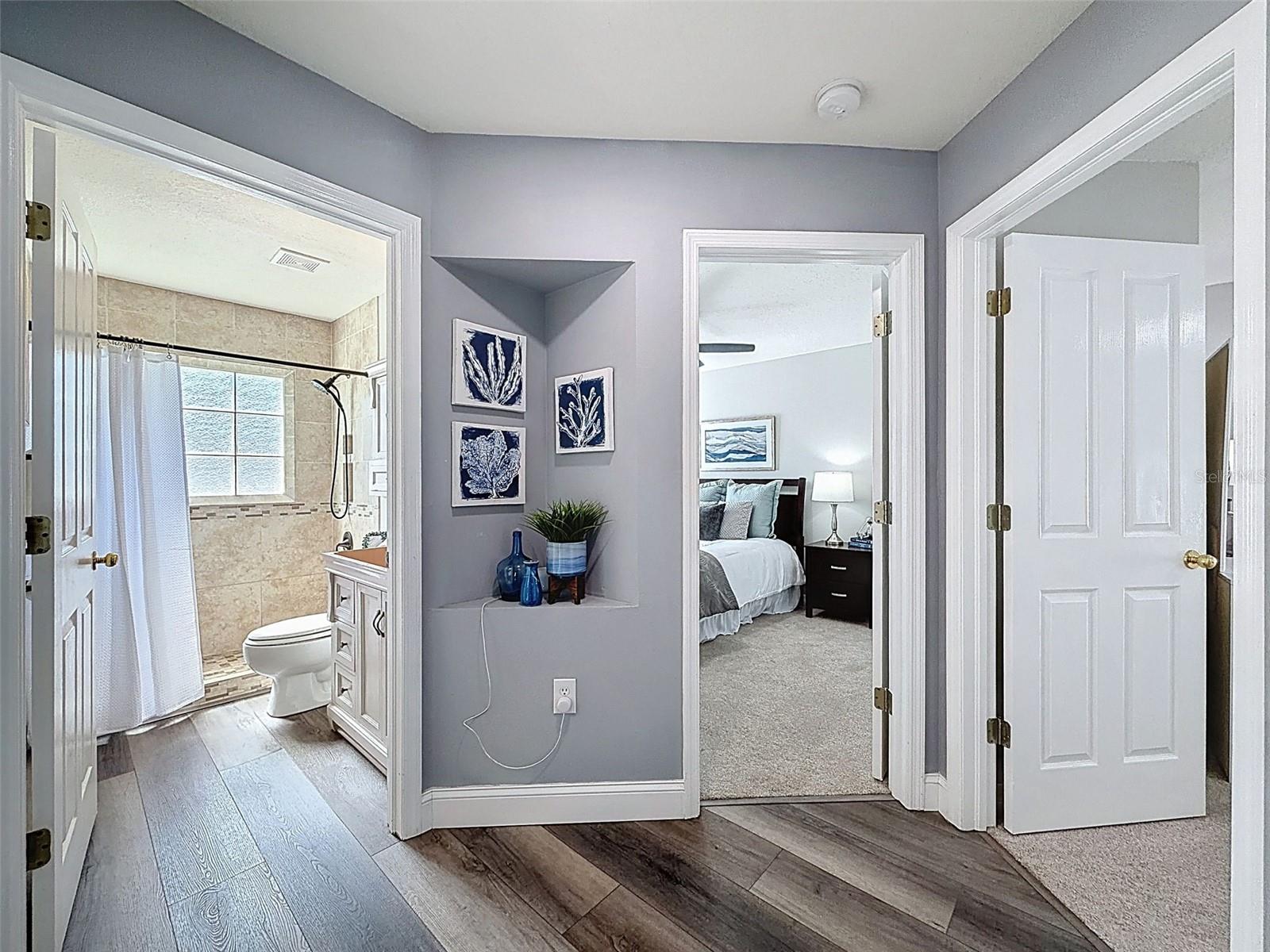 Hallway view of guest bathroom on your left and bedrooms 2 and 3 on your right.