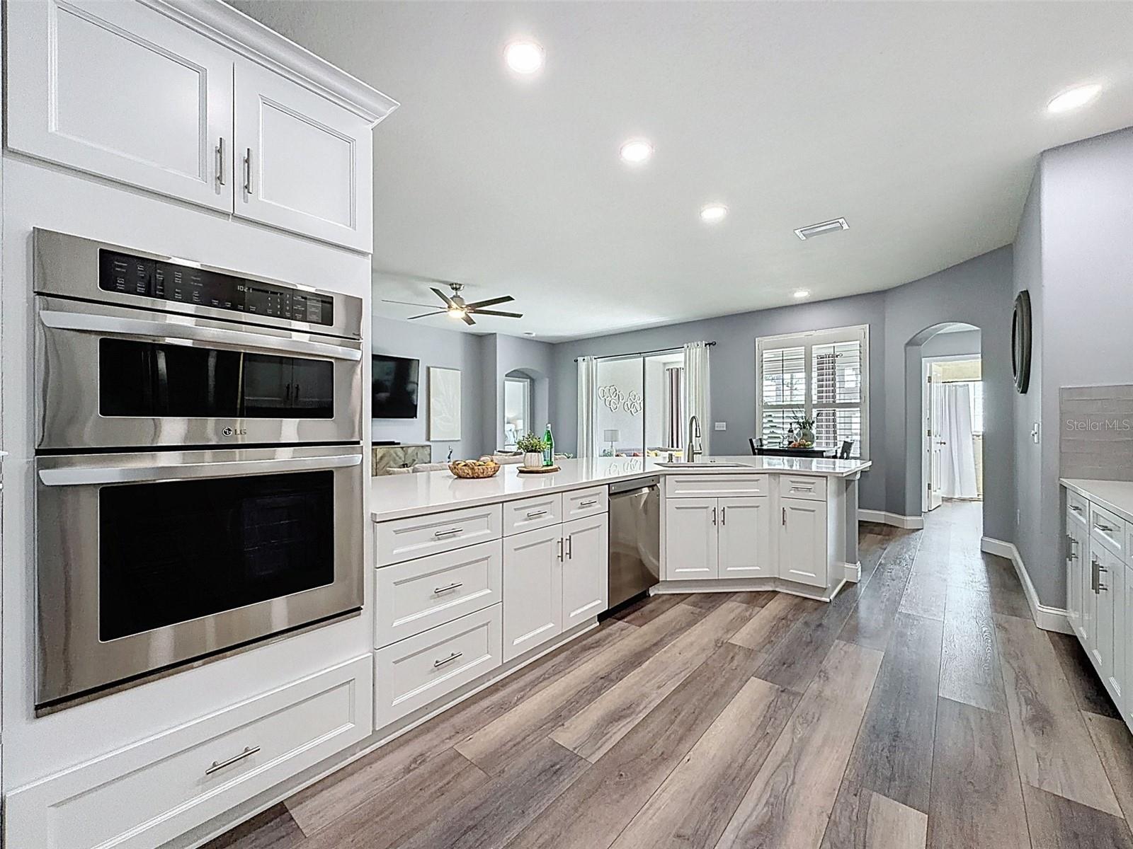 Entrance to the kitchen from hallway/laundry nook and garage.  Luxury vinyl plank flooring throughout.