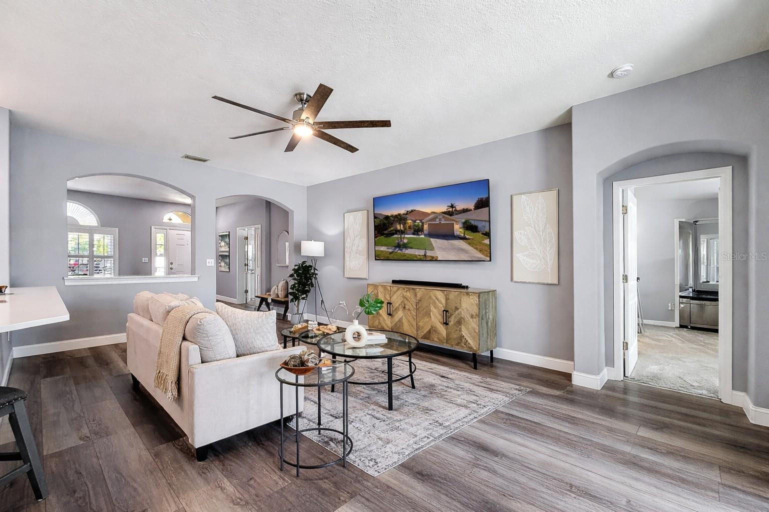 Spacious great room, arched features and entrance to master bedroom on your right.