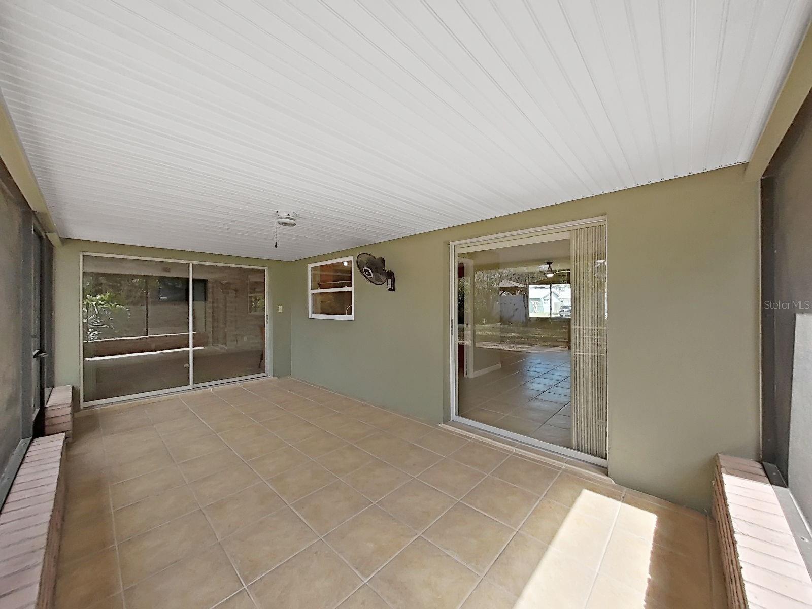 Screened Lanai connects seamlessly to both the backyard and to the interior living spaces through glass sliders. The dining room glass slider (on the right) pockets into the wall for a full open view!