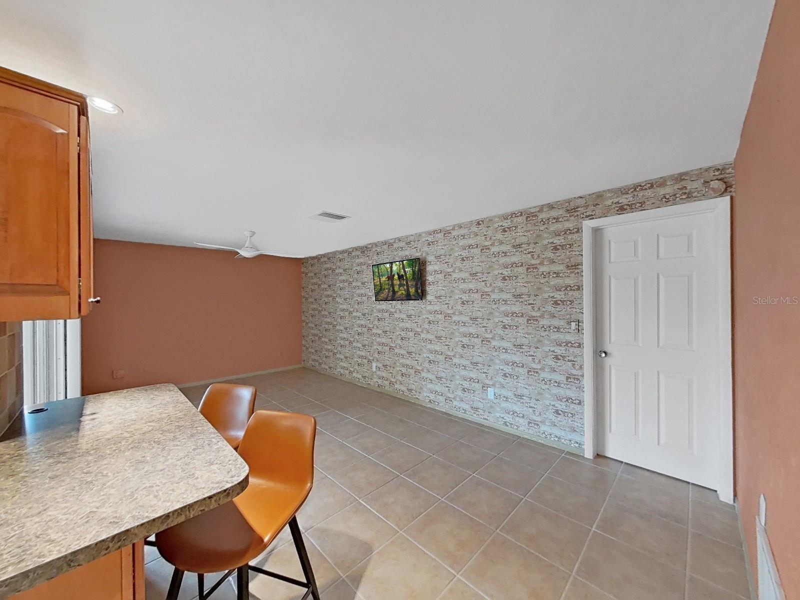 Spacious Family Room with ceiling fan, adjacent to the Kitchen. Perfect for entertaining and gathering.