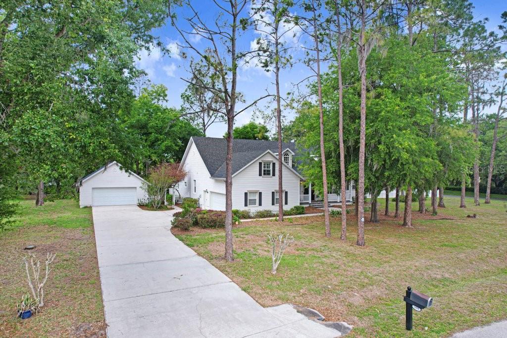 Welcome Home to your piece of paradise with 2 car attached garage AND LARGE detached garage