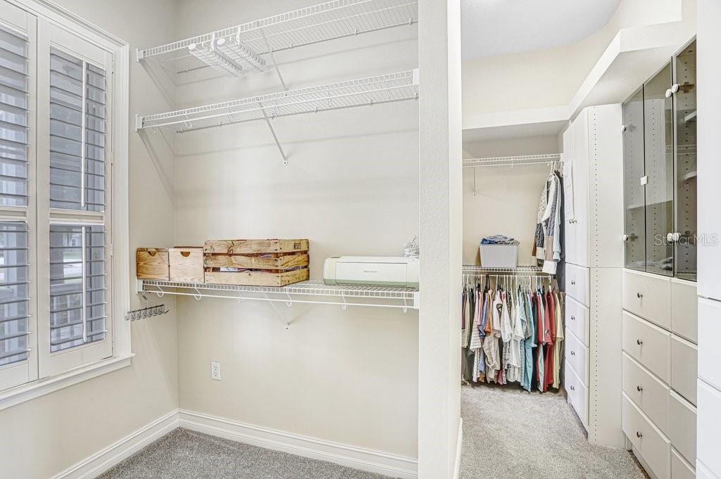 Large Walk in Closet with Custom cabinetry