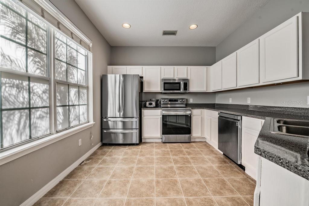 Kitchen, granite counter tops, tile flooring, lots of light.