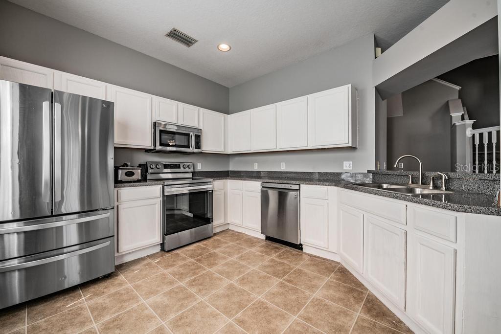 Kitchen, granite counter tops, tile flooring, lots of light.
