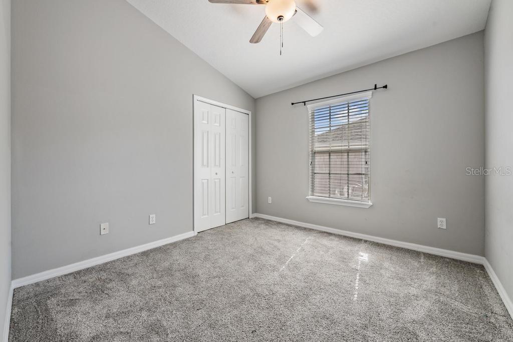 Guest Room/ceiling fan with a light fixture.