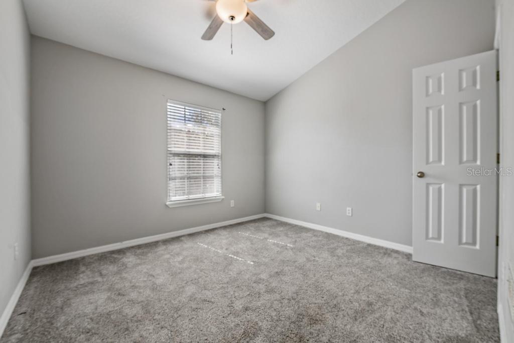 Guest Room/ceiling fan with a light fixture.