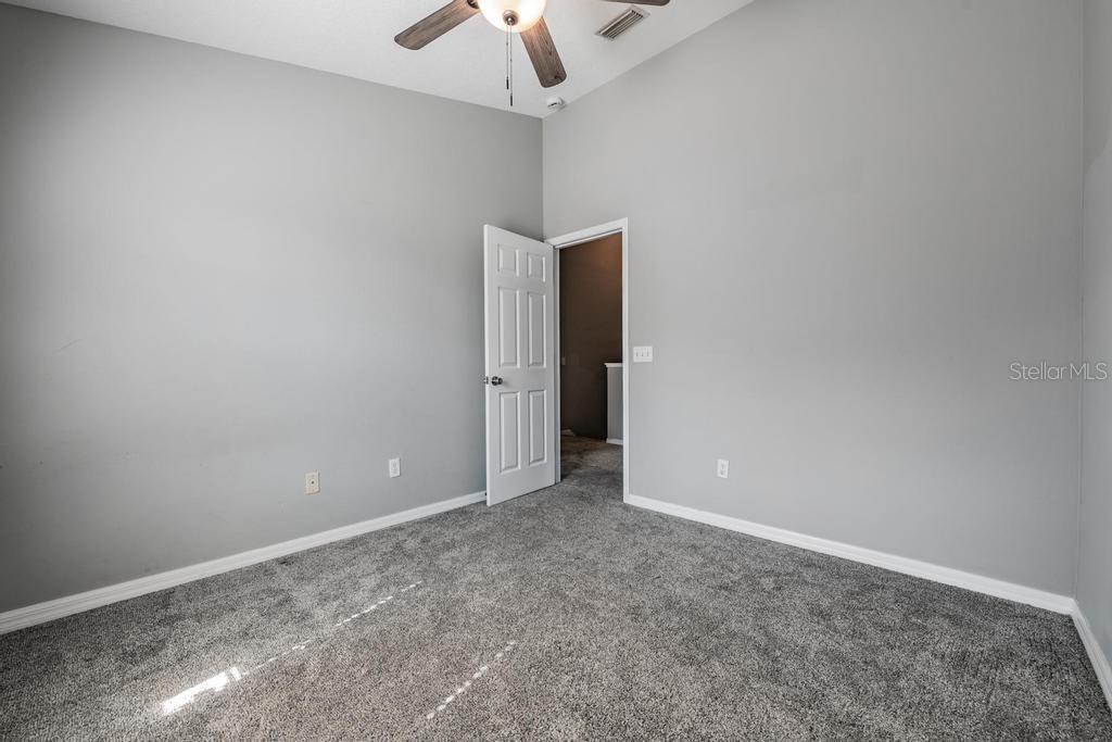 Guest Room/ceiling fan with a light fixture.