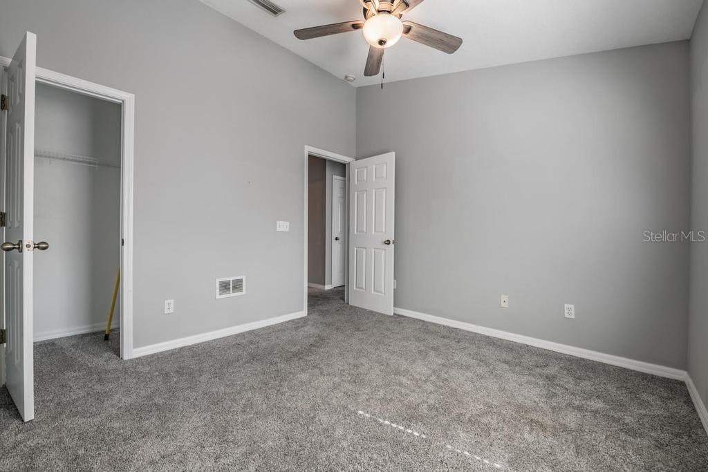 Guest Room/ceiling fan with a light fixture.