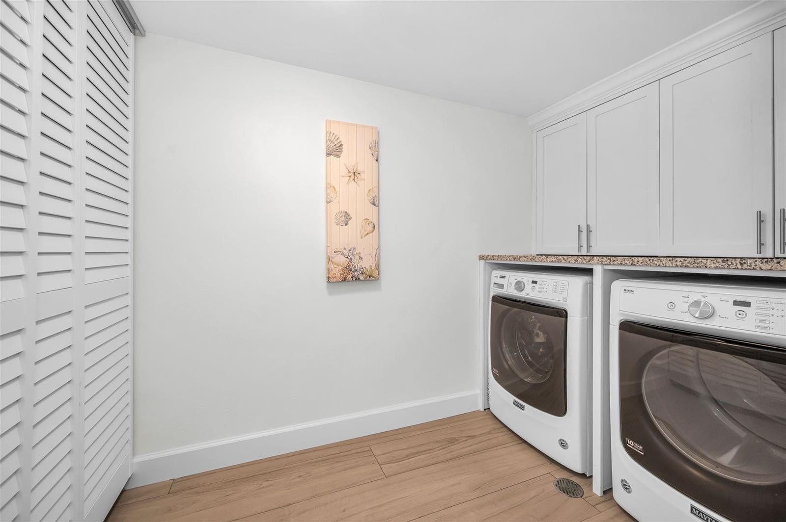 Inside Utility room with extra storage and full sized washer and dryer