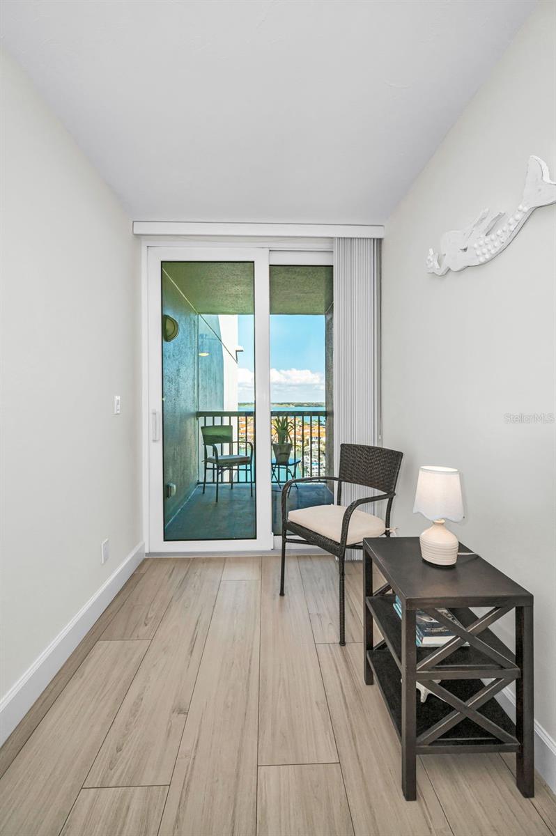 Sitting area / home office in the secondary bedroom with sliders to the private, secondary balcony