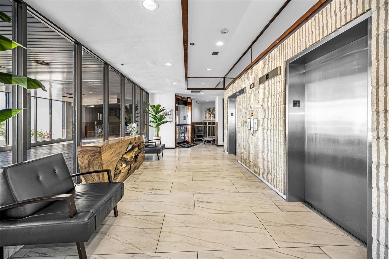 Main level elevators & sitting area & drop off spot under building