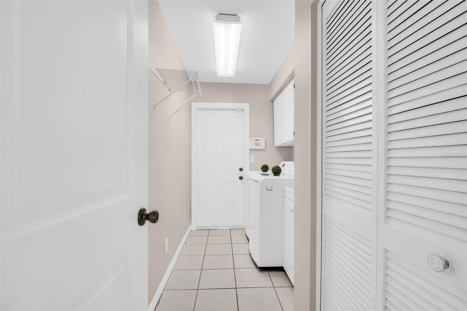 Large indoor laundry positioned between the garage & main living~