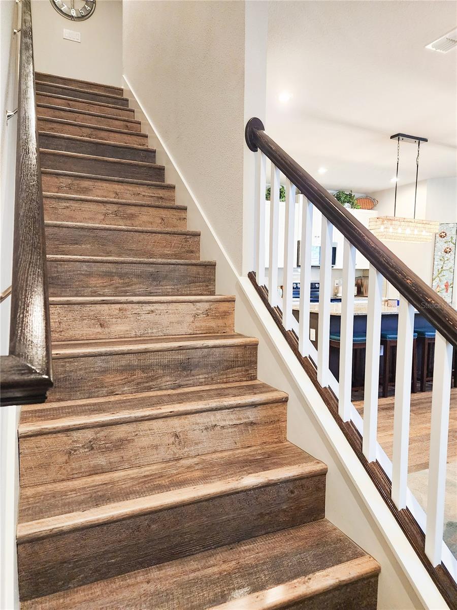 Stairs with Luxury Vinyl Plank and upgraded railing