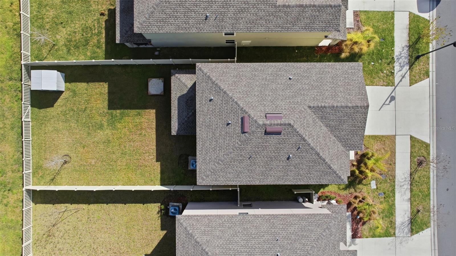 Fully fenced back yard with view of the pond.