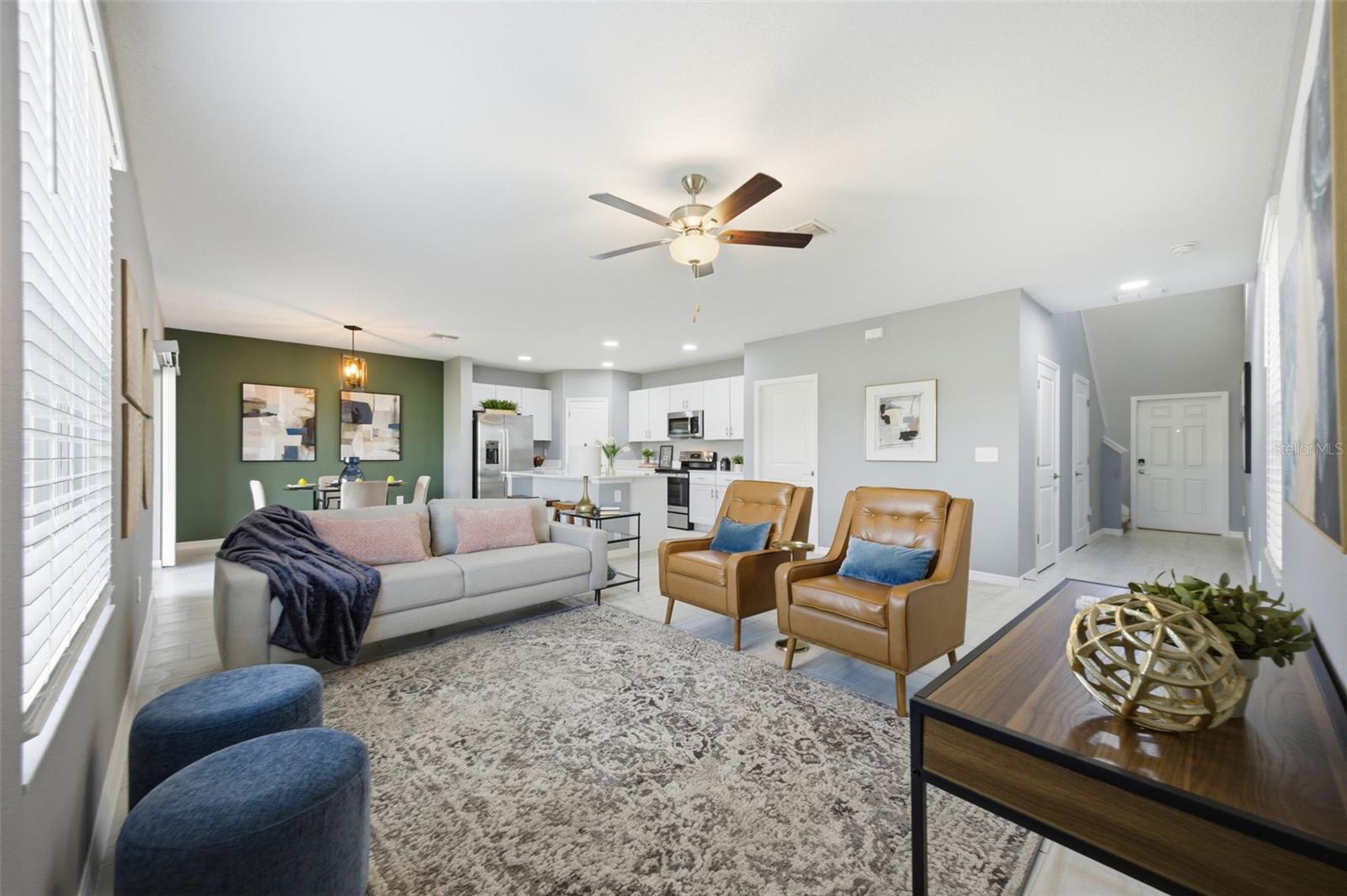 Living room, dining room and kitchen combo with a look back towards the front door.