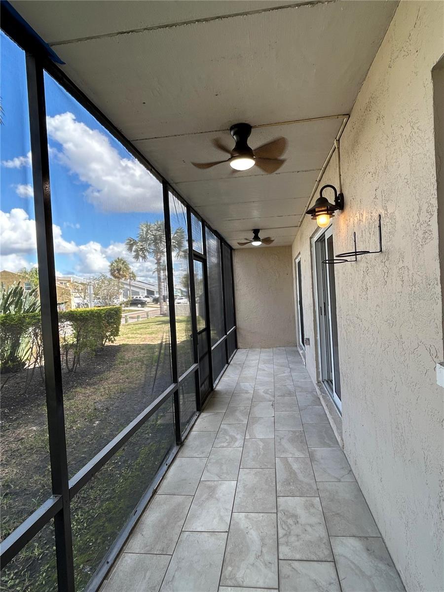Screened Lanai with tile flooring and remote-controlled ceiling fans