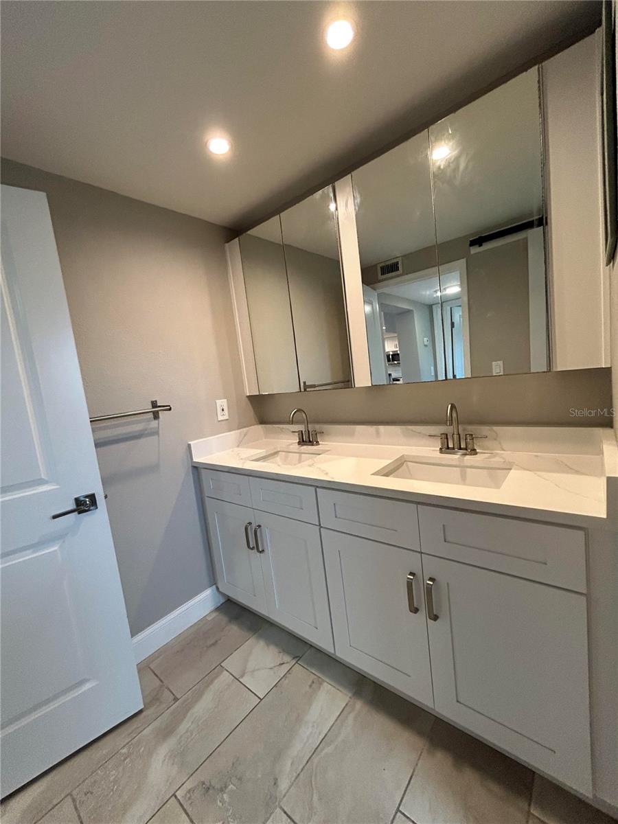 bathroom with double sink vanity and quartz counter