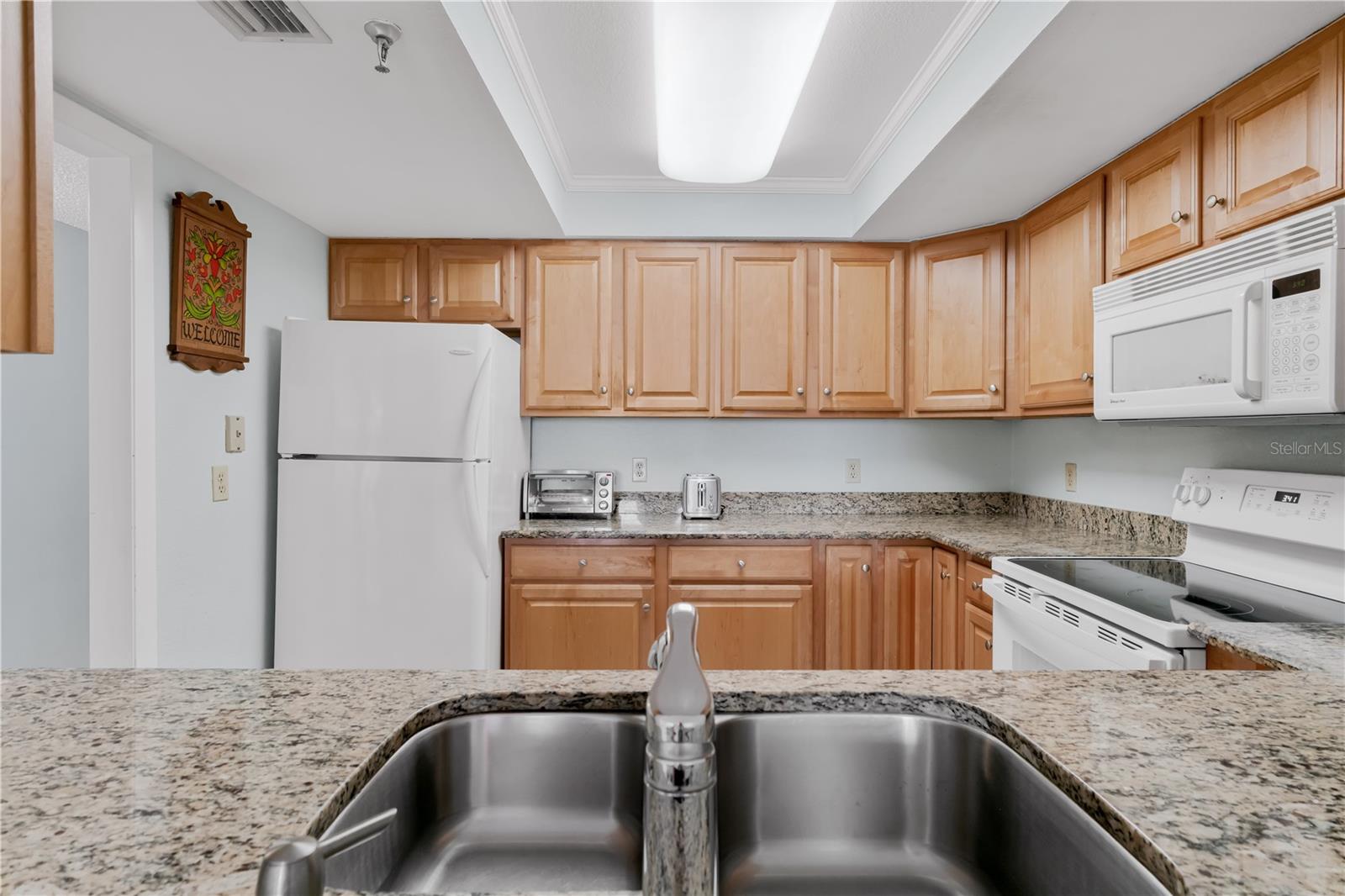 Kitchen with granite countertops and wood cabinets