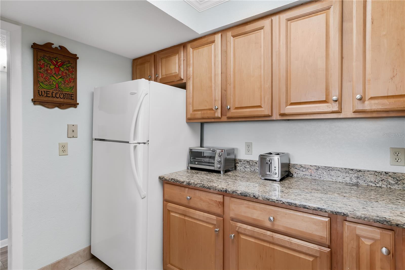 Kitchen with granite countertops and wood cabinets