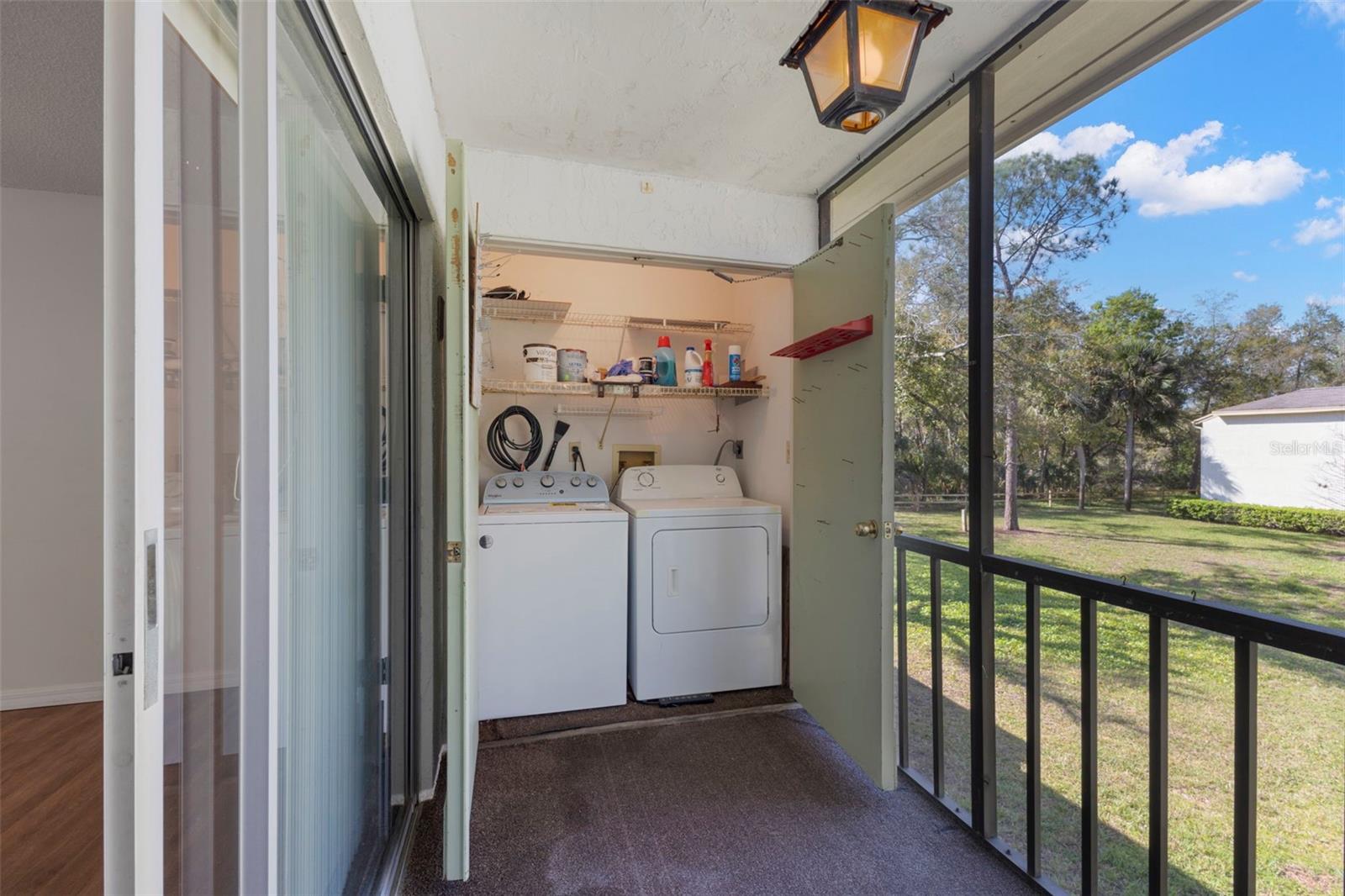 SCREENED LANAI WITH LAUNDRY CLOSET / SLIDERS TO LEFT ARE TO MAIN LIVING AREA
