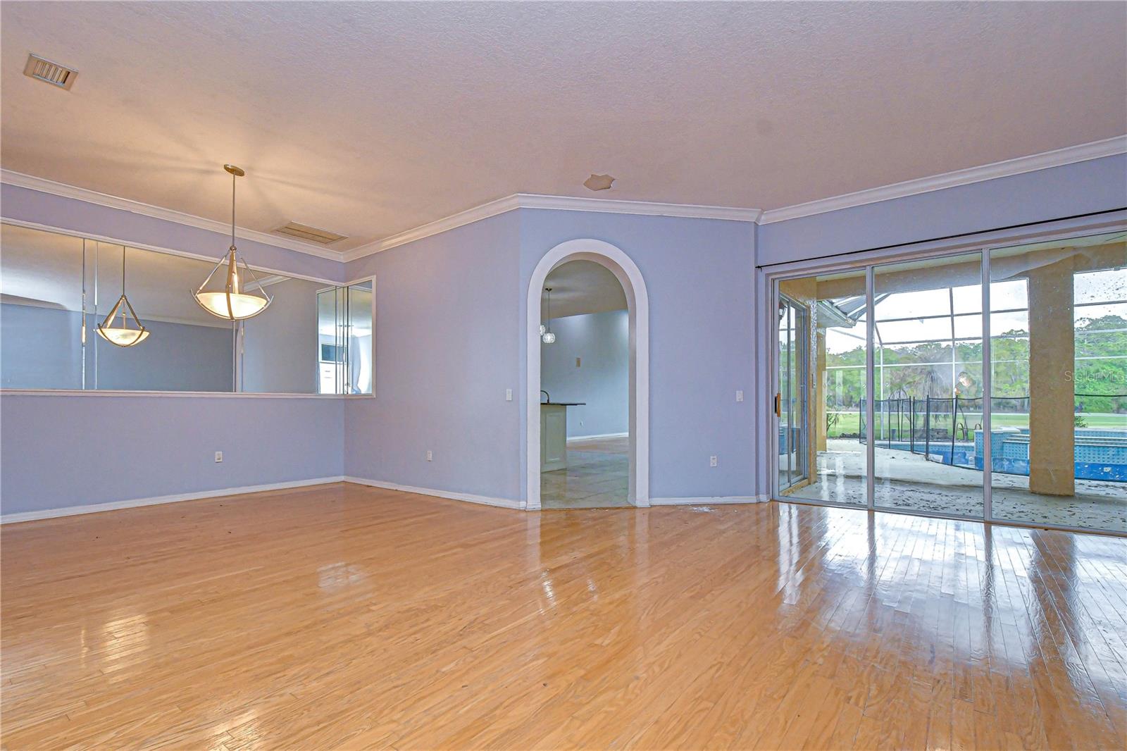 Sliders lead to Covered Lanai and Pool