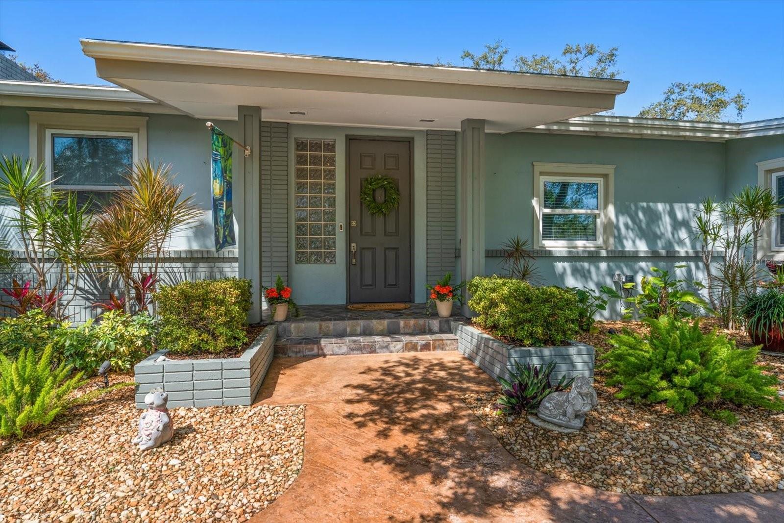 Lushly landscaped and welcoming, the front entry only hints at the impressive interior.