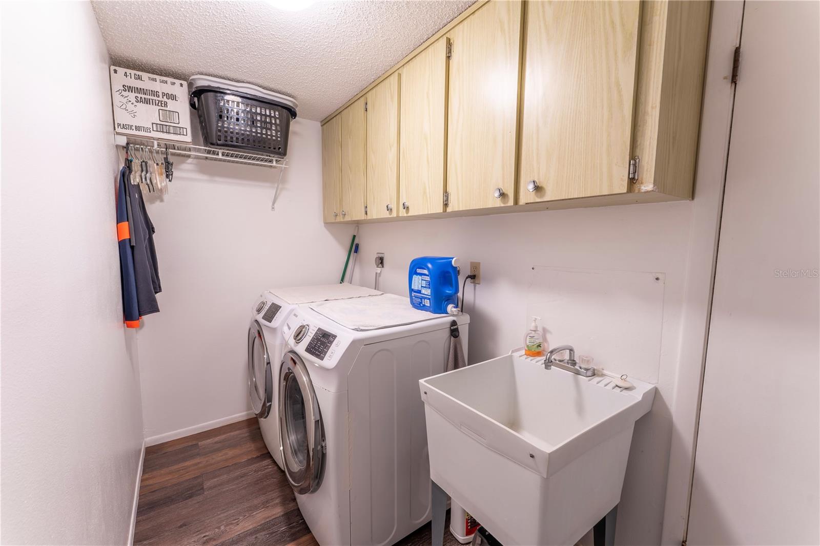 Space for side-by-side washer/dryer. Utility sink and lots of overhead cabinets.