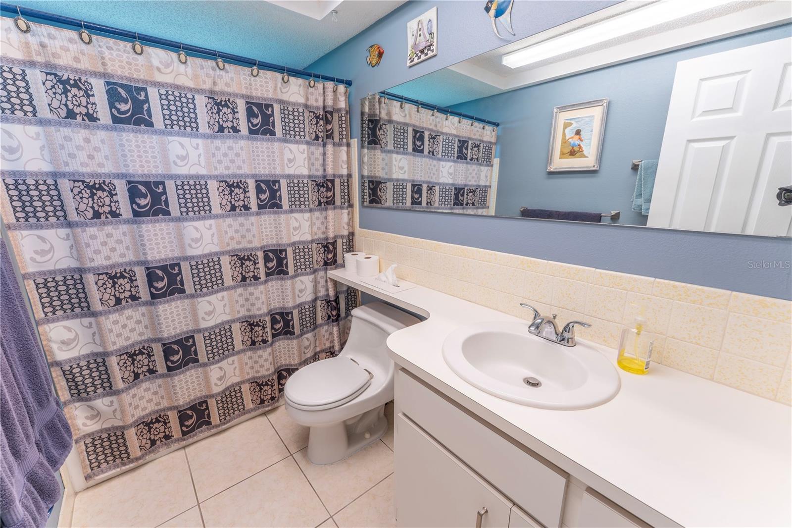 Well appointed guest bathroom with updated sink located conveniently between bedrooms 2&3.