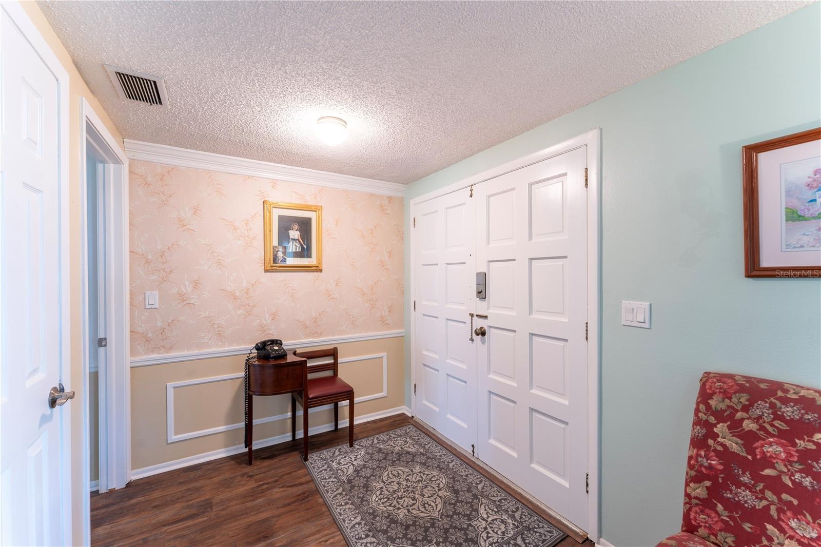 Clean, welcoming entryway with easy flow into main living spaces. Large coat closet with plenty of space for extra storage.