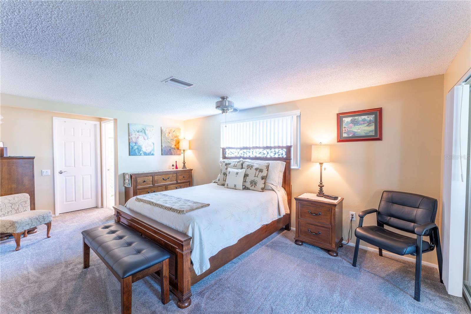 Comfortable primary retreat with a bright, airy feel and plenty of room for funishings and quiet relaxation