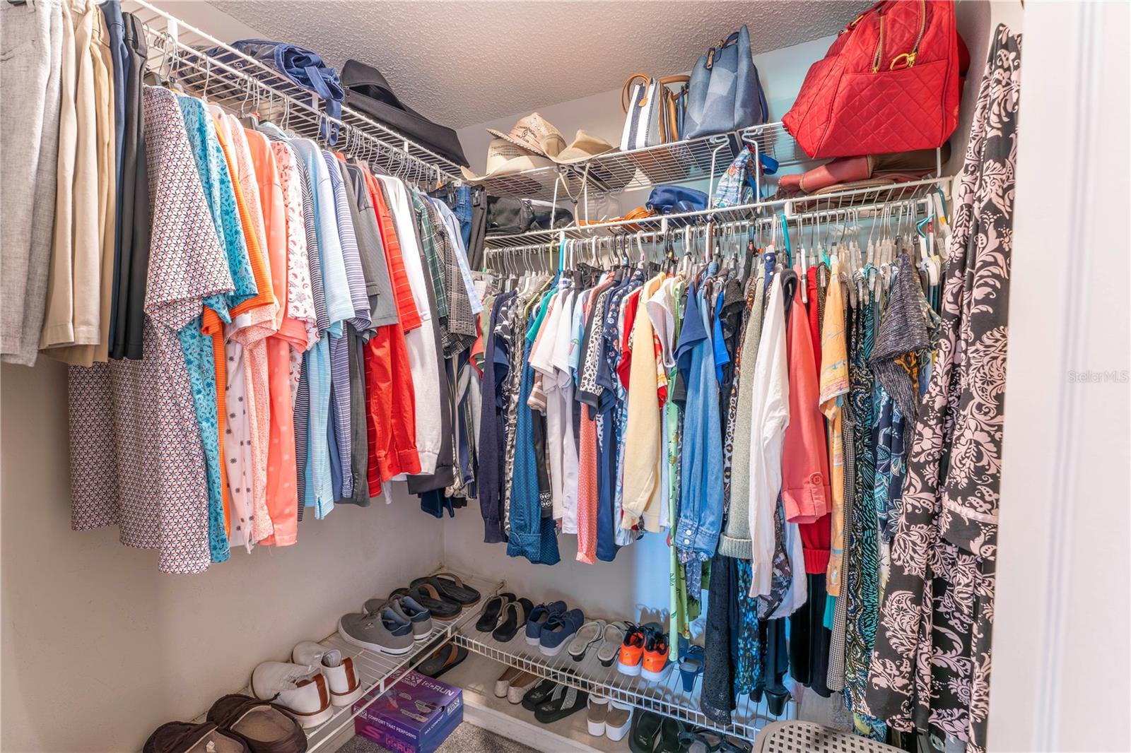 Well organized walk-in closet offering exdcellent storage with room for clothing, accessories, and seasonal items.
